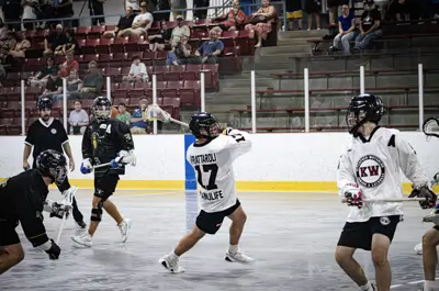 men playing lacrosse indoors