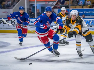 three hockey players on ice